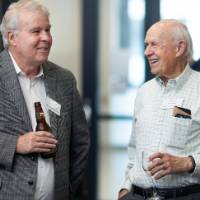 Two gentleman speaking together at event